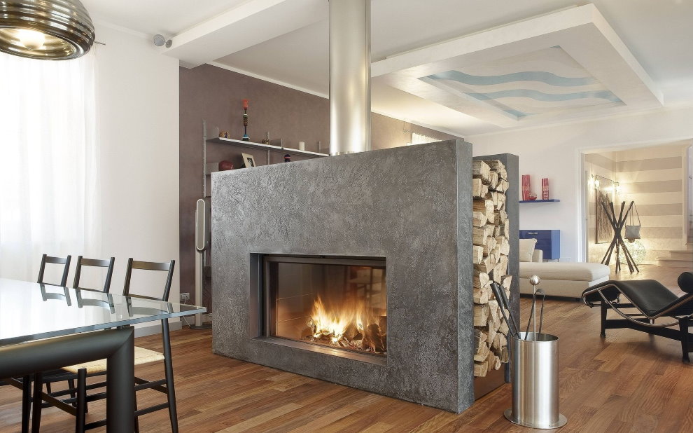 Wood fireplace with a gray portal in the center of the hall