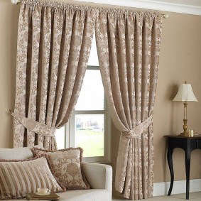 Beige curtains with assembly on the cornice