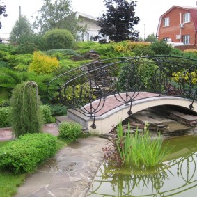 Garden bridge with metal railing