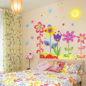 Bright flowers on the wallpaper in the daughter's bedroom