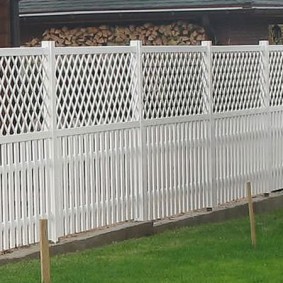 Hangar à bois derrière une clôture blanche