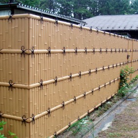 High fence with imitation of bamboo fencing