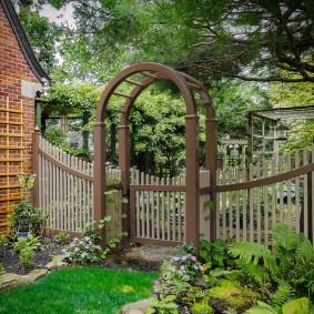 Wooden pergola above the gate in the garden