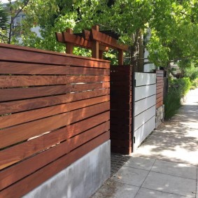 Board fence at the entrance to the courtyard of a private house