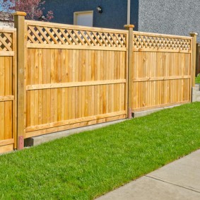 Wooden fence on a slope plot