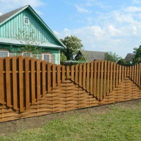 Beautiful wooden fence in front of a rural house