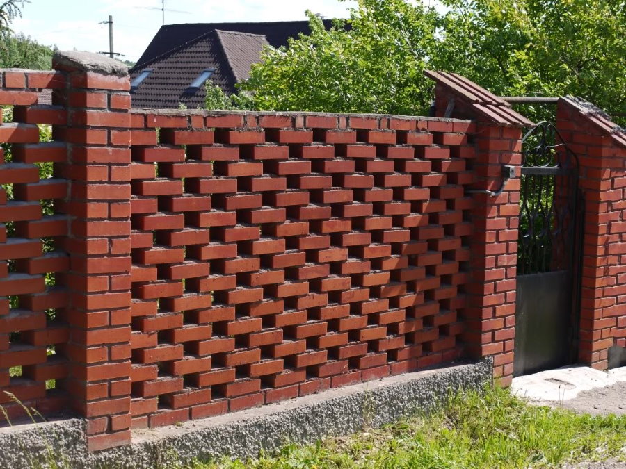 Fence in the cottage of red brick