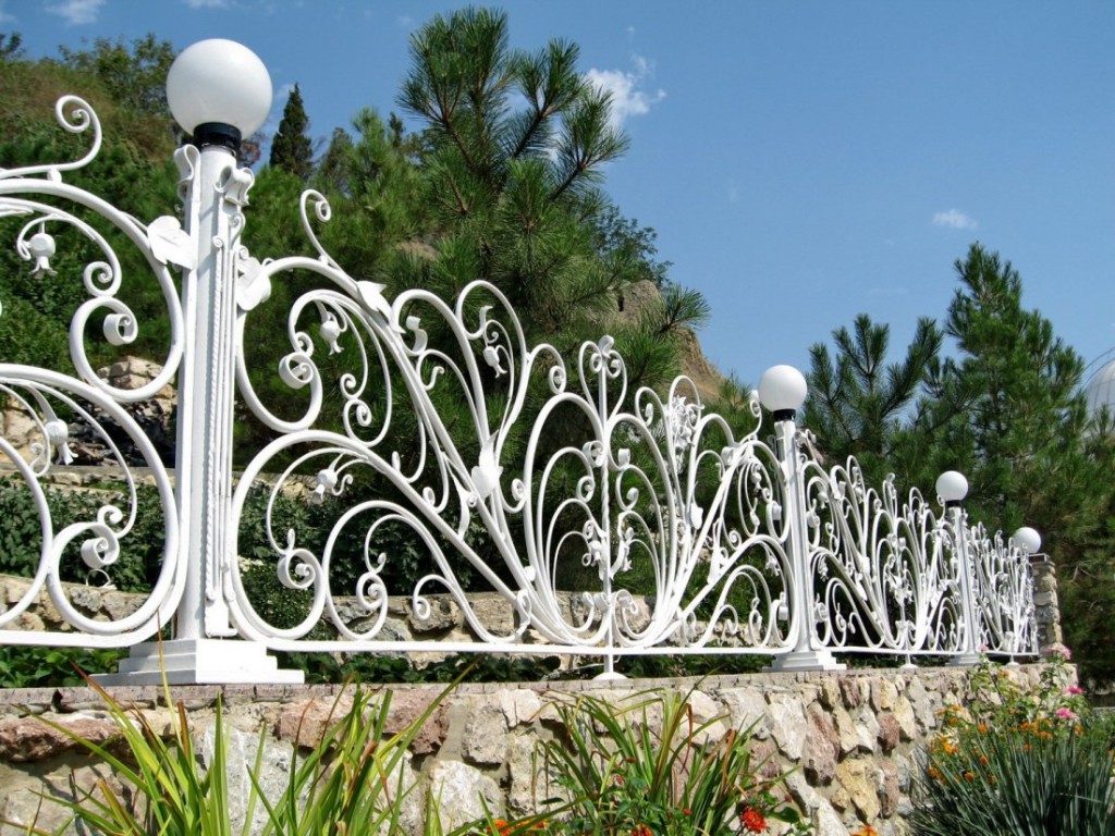 Forged fence on rubble stone foundation
