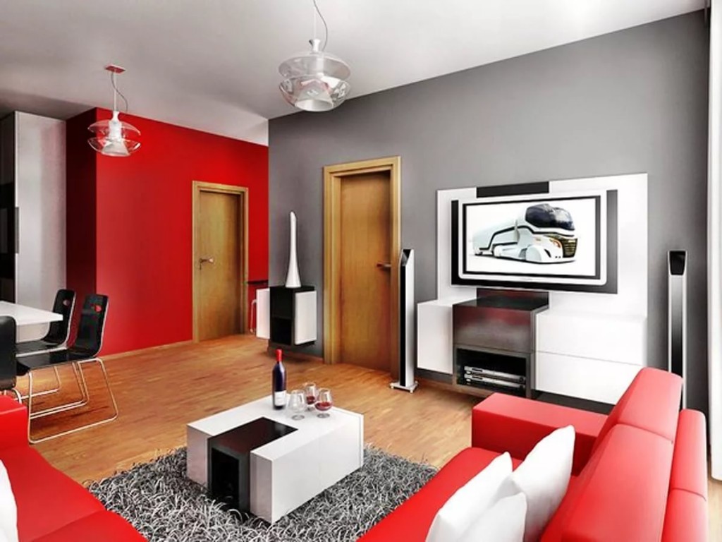 أريكة حمراء في غرفة مع جدار رمادي