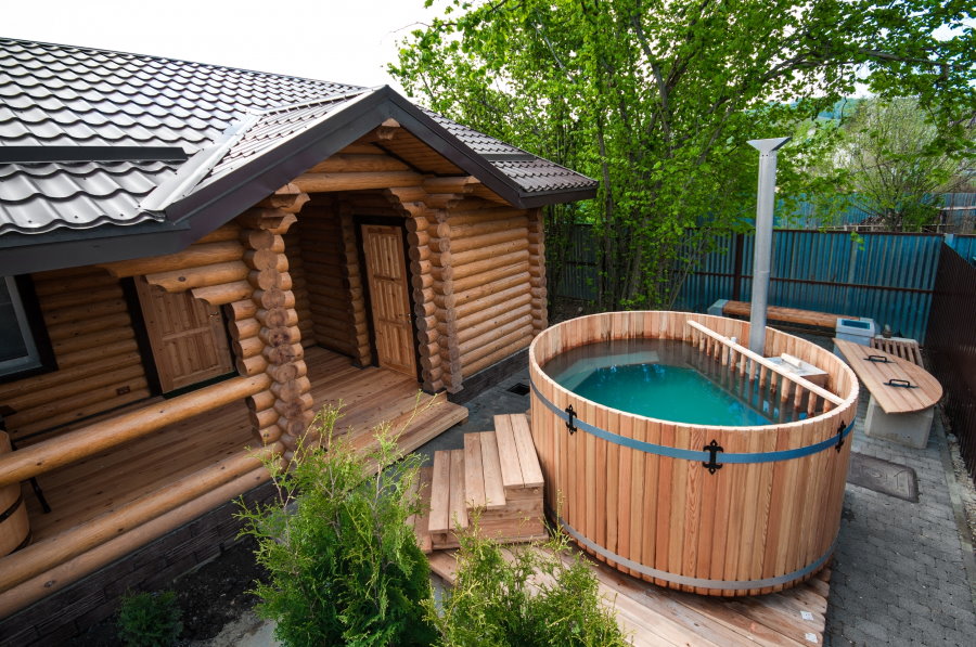 Wooden font in front of a log bath