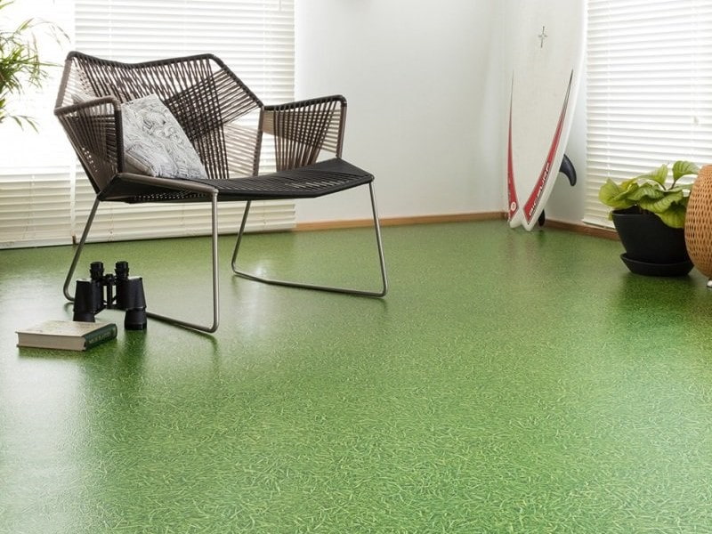 Green linoleum under the grass in the apartment hall