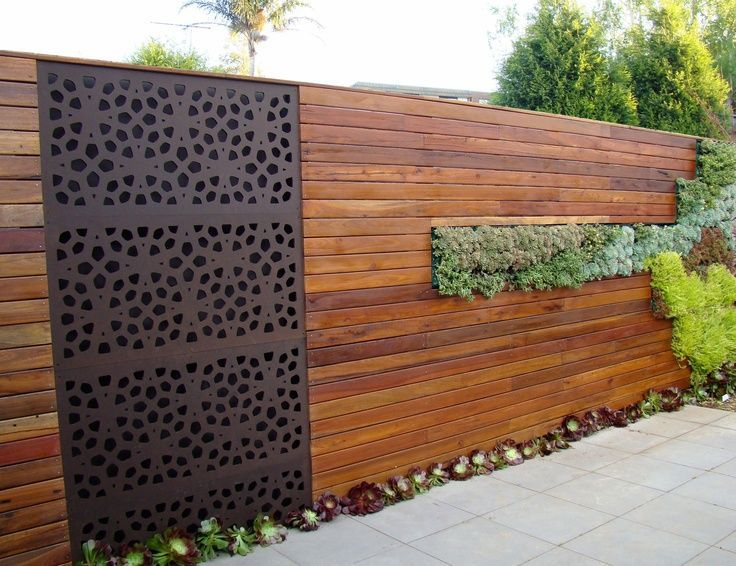 Metal insert in a wooden fence