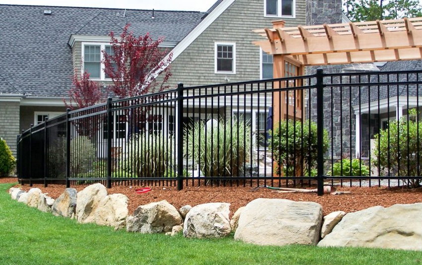 Strict metal fence in front of a country estate