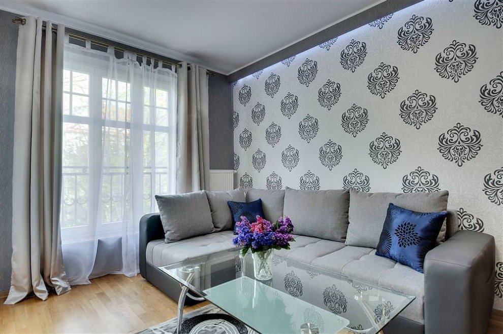 Light gray curtains are two shades lighter than the wallpaper pattern