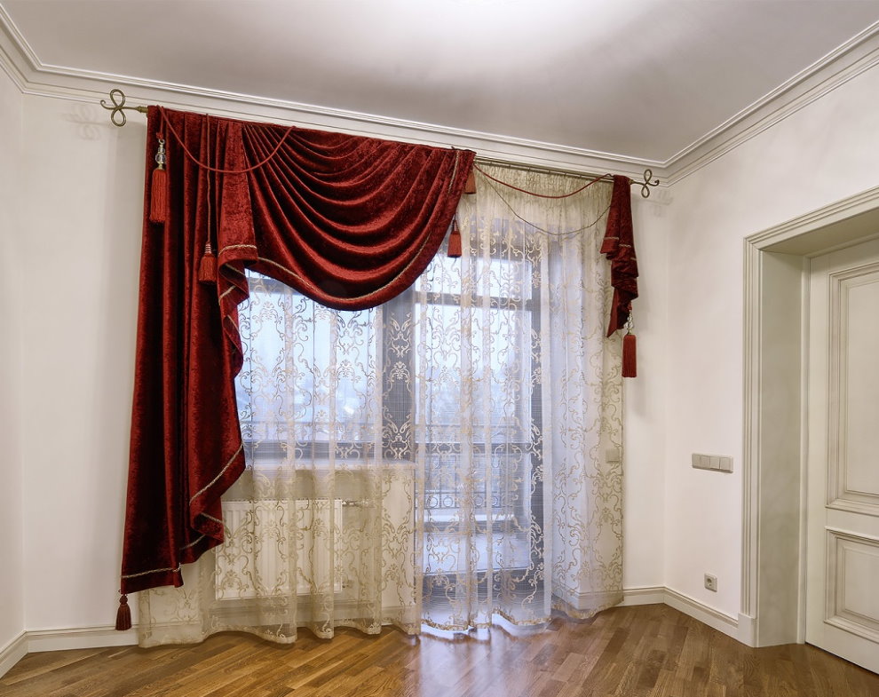Red velvet curtains on the window with a balcony door