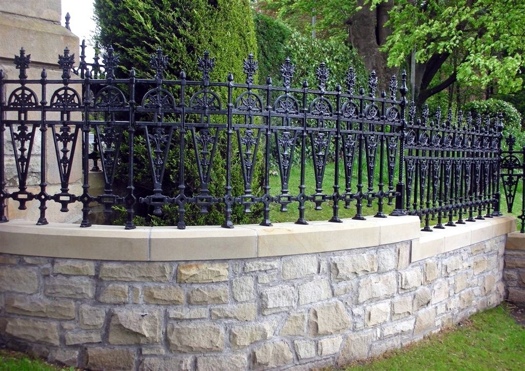 Stone foundation fence with forged sections