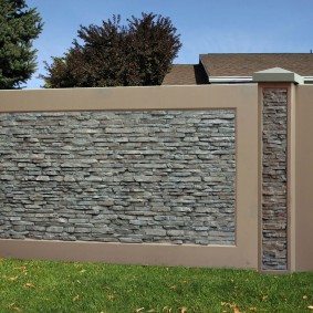 De frente para uma cerca de concreto com pedra artificial