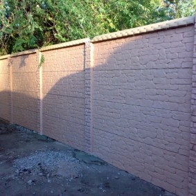 Concrete fence with imitation of old brick
