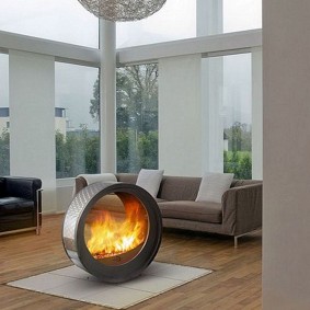 Round bio fireplace on the living room rug
