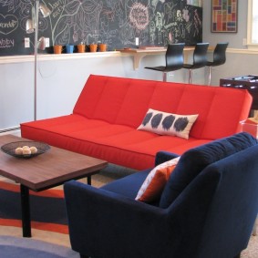 Folding sofa with red upholstery