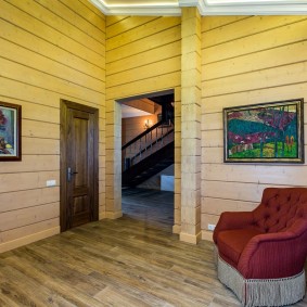Pictures in the interior of the house from a wooden beam