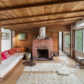 Brick fireplace in a room with wooden ceiling