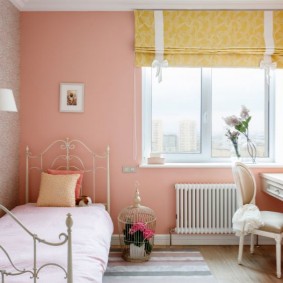 سرير معدني في غرفة مع جدار وردي