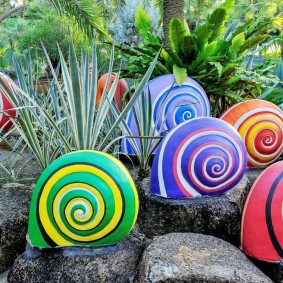 Decorative snails in a garden flower bed