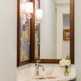 Elongated mirror in a wooden frame
