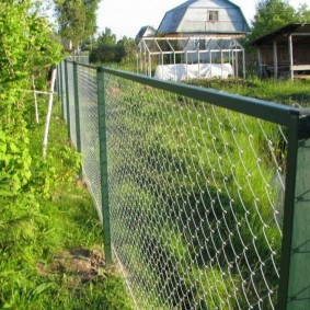 The fence of the garden area with a grid on the frame from the corners