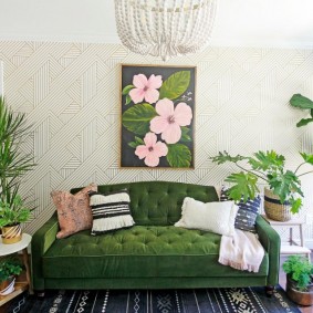 A panel with flowers over a green sofa