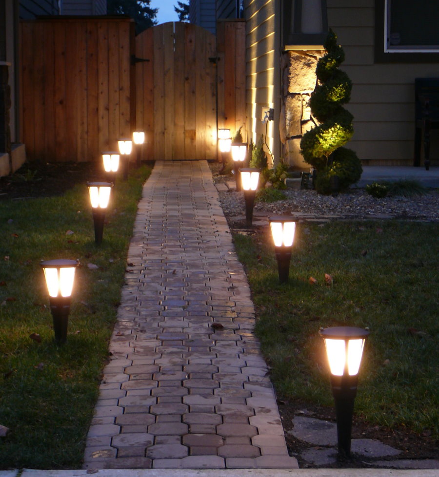 Garden lanterns along the cobblestone path