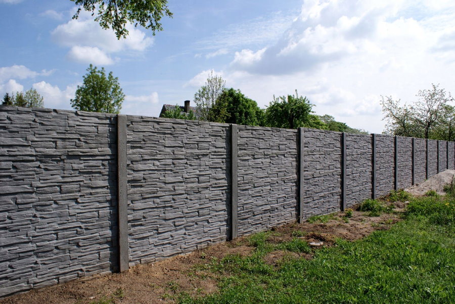 Gray concrete fence in a summer cottage