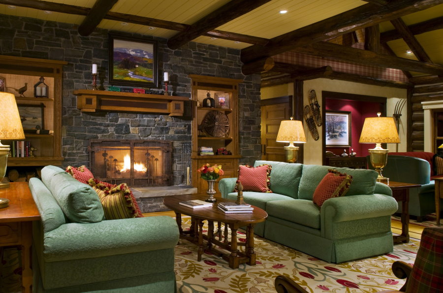 Green sofas in a rustic living room
