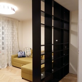 Corner sofa behind a black bookcase