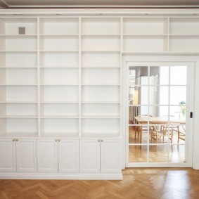 Glass door in a partition with shelves