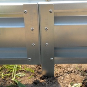 Rivets on the side of a metal bed with galvanization